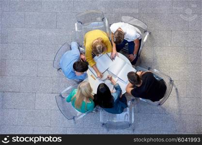 top view, group of students together at school table working homework and have fun