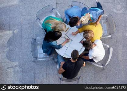 top view, group of students together at school table working homework and have fun