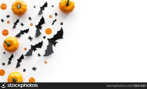 Top view halloween concept with pumpkins and bats