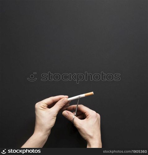 top view hand cutting cigarette. Beautiful photo. top view hand cutting cigarette