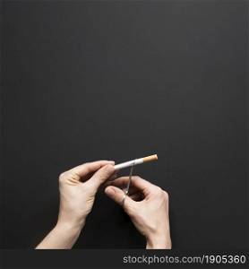 top view hand cutting cigarette. Beautiful photo. top view hand cutting cigarette