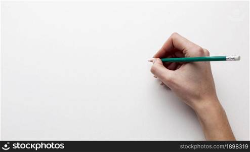 top view hand holding pencil with copy space. Resolution and high quality beautiful photo. top view hand holding pencil with copy space. High quality beautiful photo concept