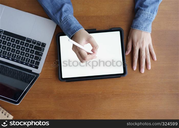 Top view hand of asian women are using tablet on wood table
