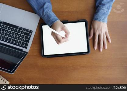 Top view hand of asian women are using tablet on wood table