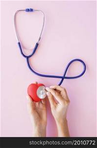 top view hands checking heart with stethoscope