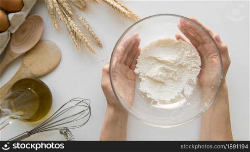 top view hands holding bowl with flour. Resolution and high quality beautiful photo. top view hands holding bowl with flour. High quality and resolution beautiful photo concept