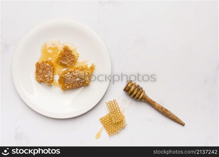 top view honey spoon with honeycomb pieces