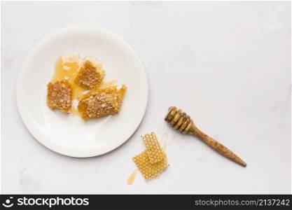 top view honey spoon with honeycomb pieces