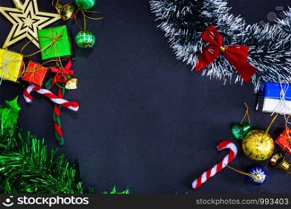 Top view image of Christmas festive decorations with empty on black paper background, New Year concept.