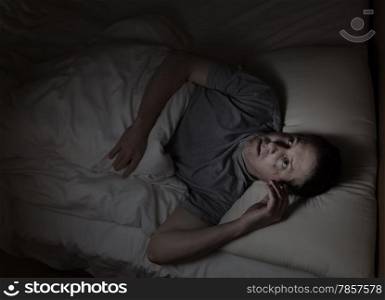 Top view image of mature man restless in bed from insomnia