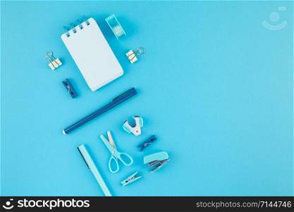 Top view knolling flat lay of workspace desk styled design school and office supplies with copy space turquoise blue color paper background minimal style. Template for feminine blog social media