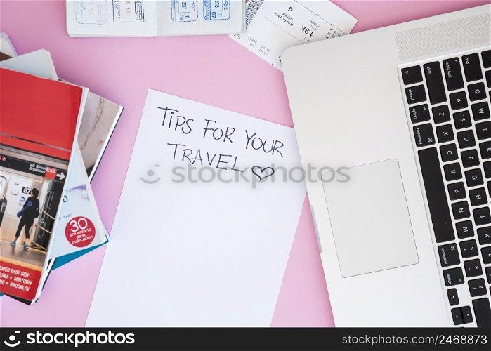 top view laptop surrounded by travel things
