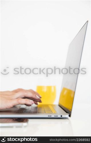 top view laptop with orange juice