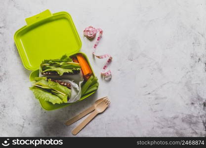 top view lunch box with measuring tape cutlery