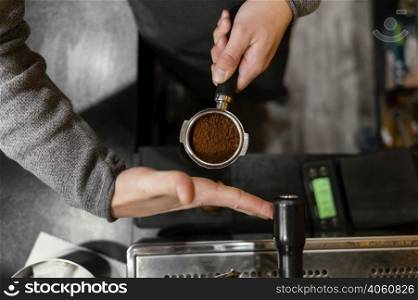 top view male barista holding professional coffee machine cup