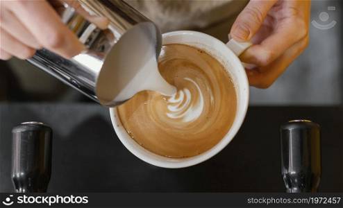 top view male barista pouring milk coffee cups. High resolution photo. top view male barista pouring milk coffee cups. High quality photo