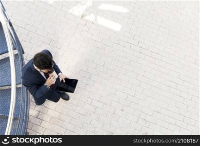 top view man with tablet drinking coffee