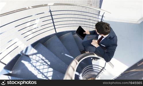 top view man with tablet standing stairs. High resolution photo. top view man with tablet standing stairs. High quality photo
