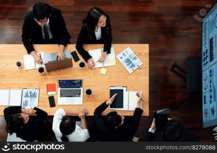 Top view manager or office worker give presentation in harmony conference room to business colleague, BI data dashboard on screen and pile of financial analyzed data reports on meeting table.. Top view business presentation at harmony conference room with colleagues.