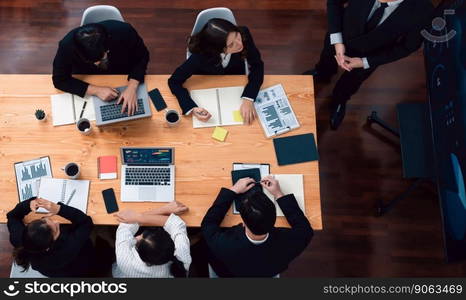 Top view manager or office worker give presentation in harmony conference room to business colleague, BI data dashboard on screen and pile of financial analyzed data reports on meeting table.. Top view business presentation at harmony conference room with colleagues.