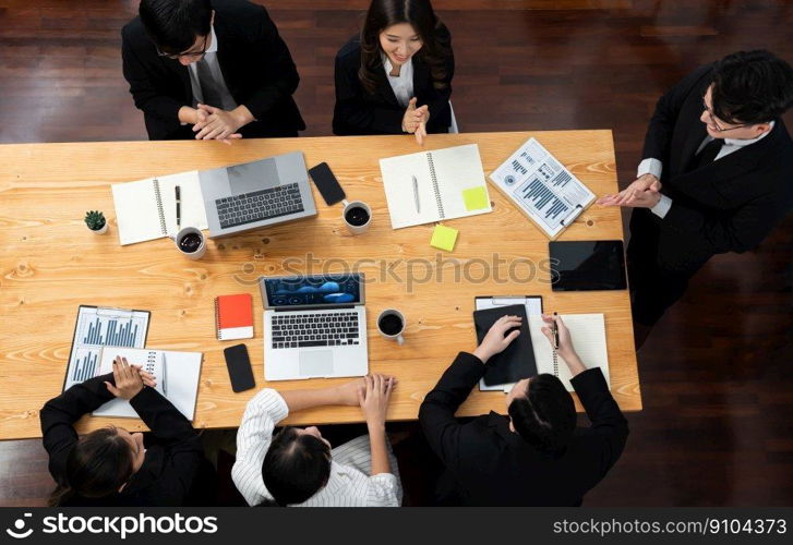 Top view manager or office worker give presentation in harmony conference room to business colleague, BI data dashboard on screen and pile of financial analyzed data reports on meeting table.. Top view business presentation at harmony conference room with colleagues.