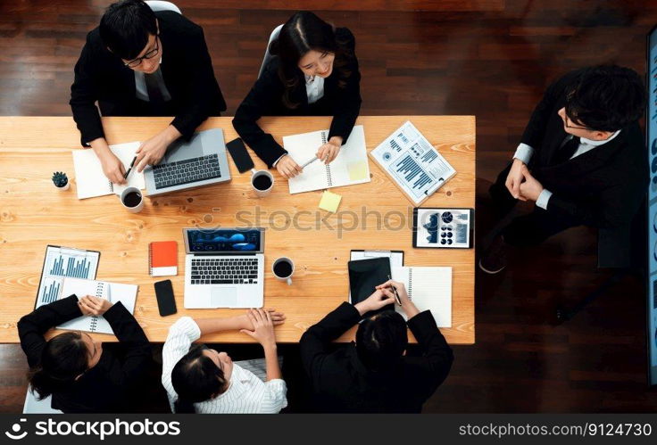 Top view manager or office worker give presentation in harmony conference room to business colleague, BI data dashboard on screen and pile of financial analyzed data reports on meeting table.. Top view business presentation at harmony conference room with colleagues.