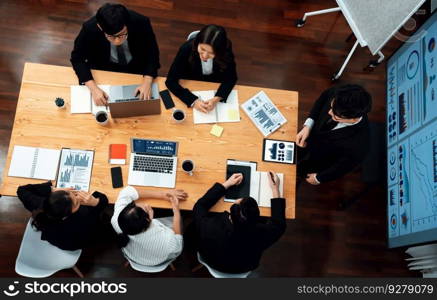 Top view manager or office worker give presentation in harmony conference room to business colleague, BI data dashboard on screen and pile of financial analyzed data reports on meeting table.. Top view business presentation at harmony conference room with colleagues.