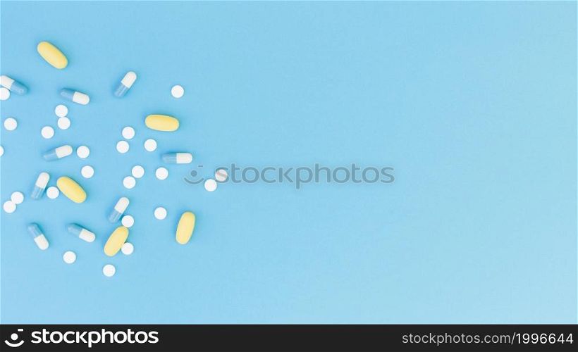 top view medical pills capsules blue background