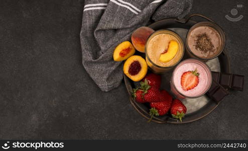 top view milkshake glasses with fruits chocolate