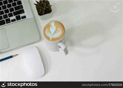Top view mouse computer laptop and pencil coffee cup flat lay on desk.