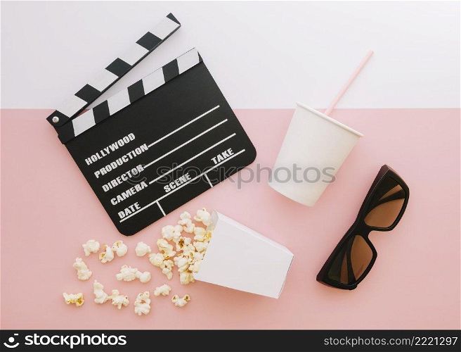 top view movie clapperboard with popcorn