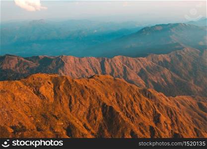 Top View Mulayit Taung golden light of the morning sun and the mist covered on Mount Mulayit,Myanmar