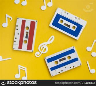 top view multicolored cassette tapes with decorative musical notes around