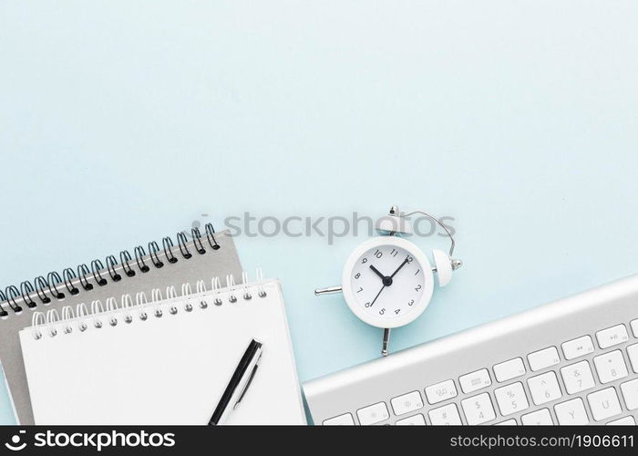 top view notebook clock arrangement. High resolution photo. top view notebook clock arrangement. High quality photo