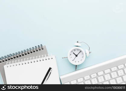 top view notebook clock arrangement. High resolution photo. top view notebook clock arrangement. High quality photo