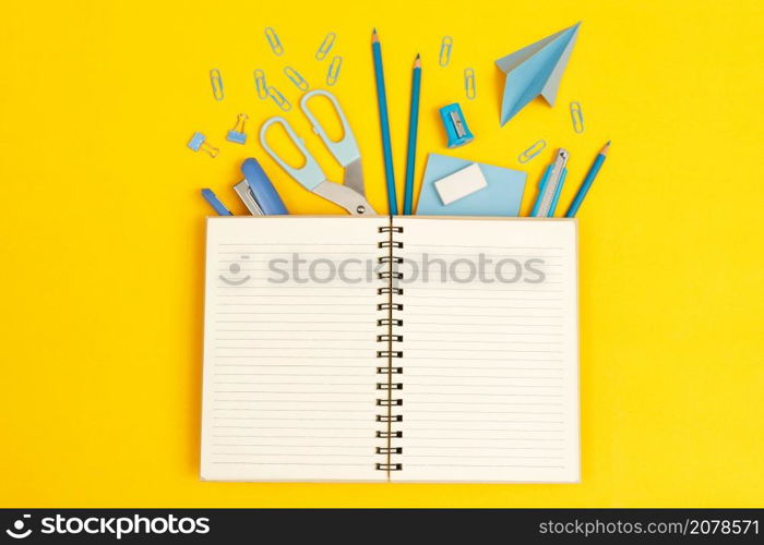 Top view notebooks and accessories stationery studying in the library at school yellow background idea education