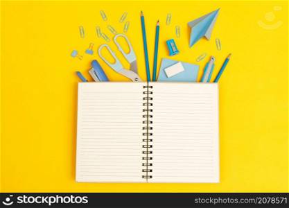 Top view notebooks and accessories stationery studying in the library at school yellow background idea education
