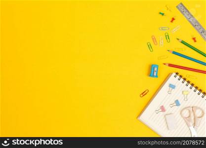Top view notebooks and accessories studying in the library at school yellow background idea education