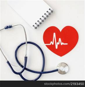 top view notepad with stethoscope paper heart