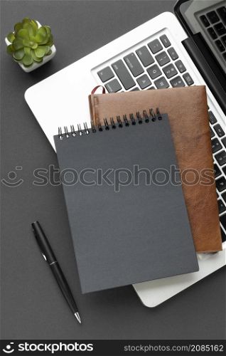top view notepads laptop arrangement