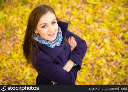 Top view of a beautiful girl against the backdrop of autumn foliage