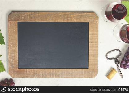 Top view of a blank chalk board for a wine list or menu with Wine and grapes over grey concrete background