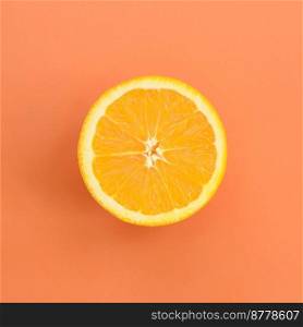 Top view of a one orange fruit slice on bright background in orange color. A saturated citrus texture image