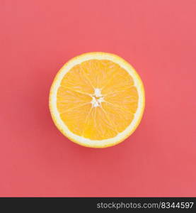 Top view of a one orange fruit slice on bright background in red color. A saturated citrus texture image