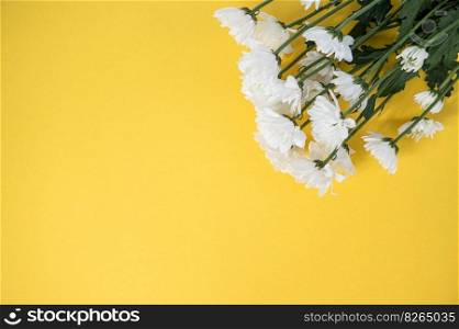 Top view of a yellow table with a mockup of blank notebooks with a bouquet of roses on the side.. Top view of a yellow table with a mockup of empty notebooks with a bouquet of roses. Place for text