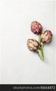 Top view of artichokes on concrete background