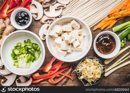 Top view of Asian vegetarian cooking ingredients for stir fry with tofu, noodles and vegetables