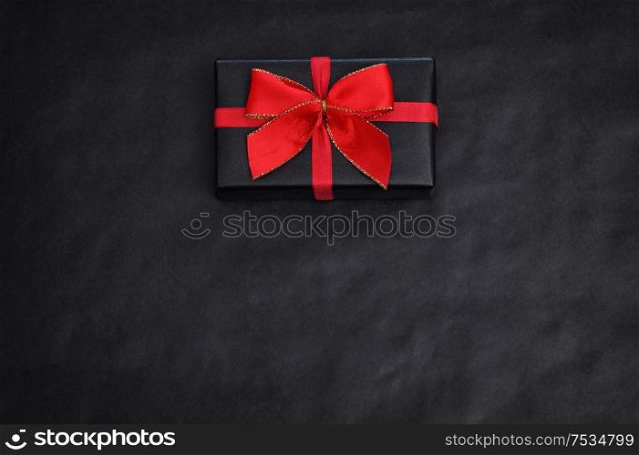Top View Of Black Paper And A Gift