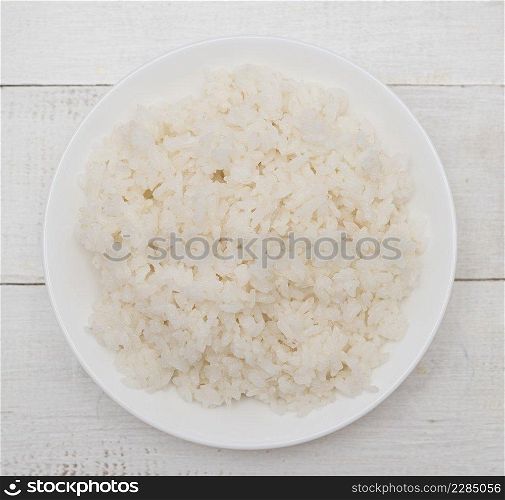 Top view of boiled rice in a bowl on wooden background