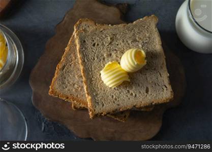 Top view of Bread and butter with a glass of milk